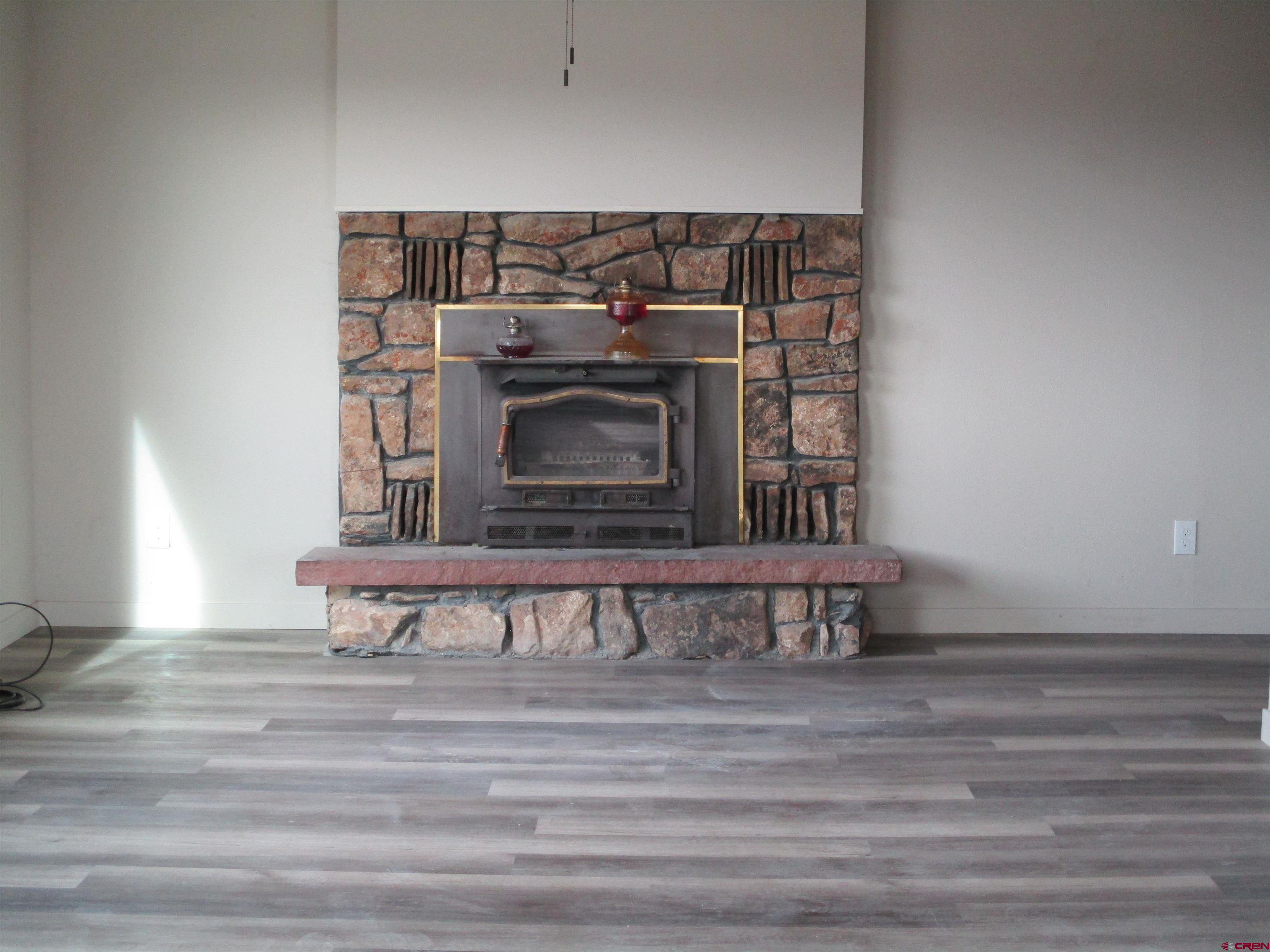 18950 Beaver Road Delta, CO 81416 - Photo 3 of 10 a living room with a fireplace
