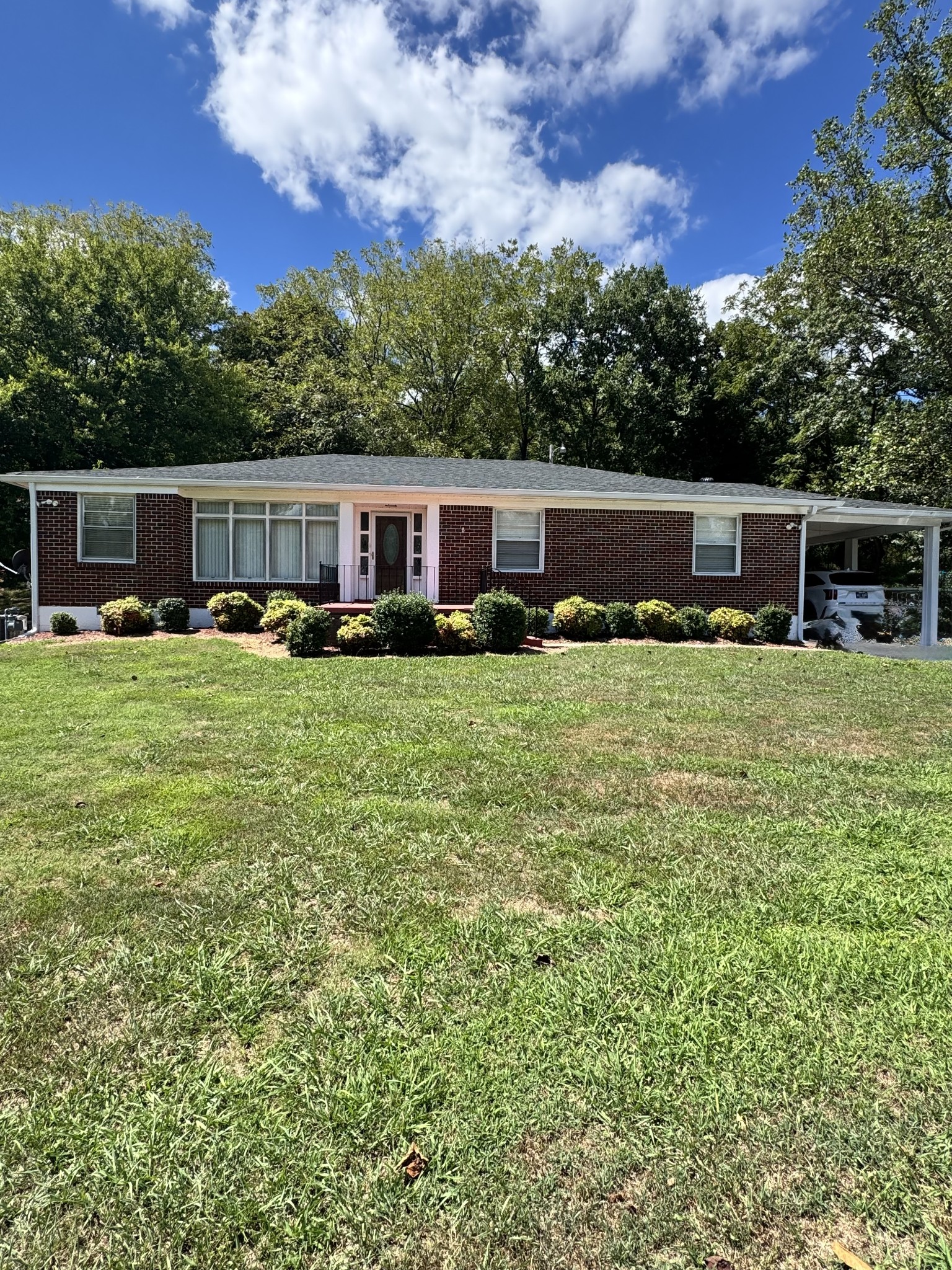 a view of a house with yard and sitting area