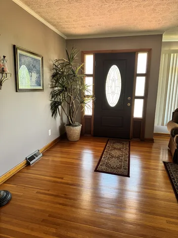 a view of a room with wooden floor and window