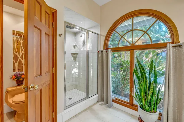 a bedroom with a bed dresser and a window