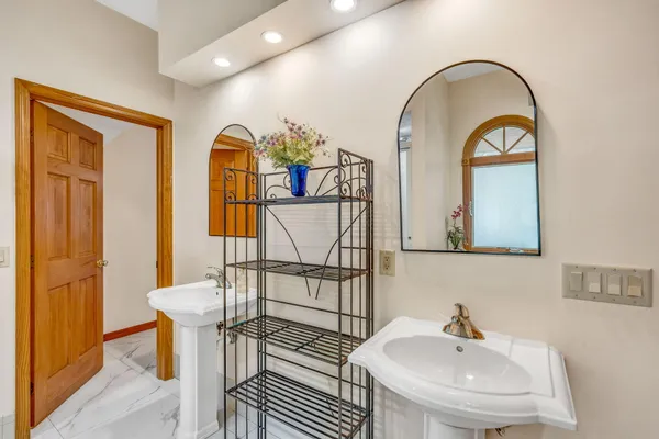 a view of spacious bathroom with a tub and large windows