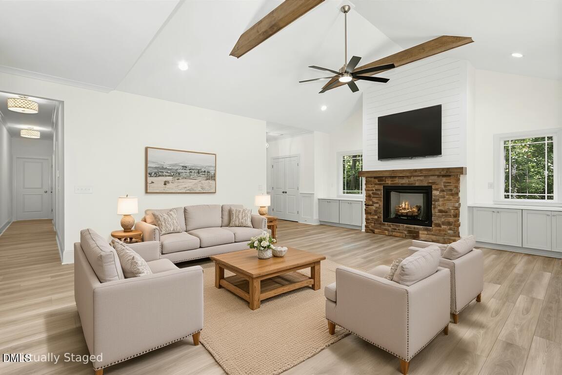 925 Lynch Road Selma, NC 27576 - Photo 11 of 39 a living room with furniture a flat screen tv and a fireplace