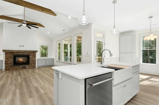 a view of a livingroom with a fireplace wooden floor and window