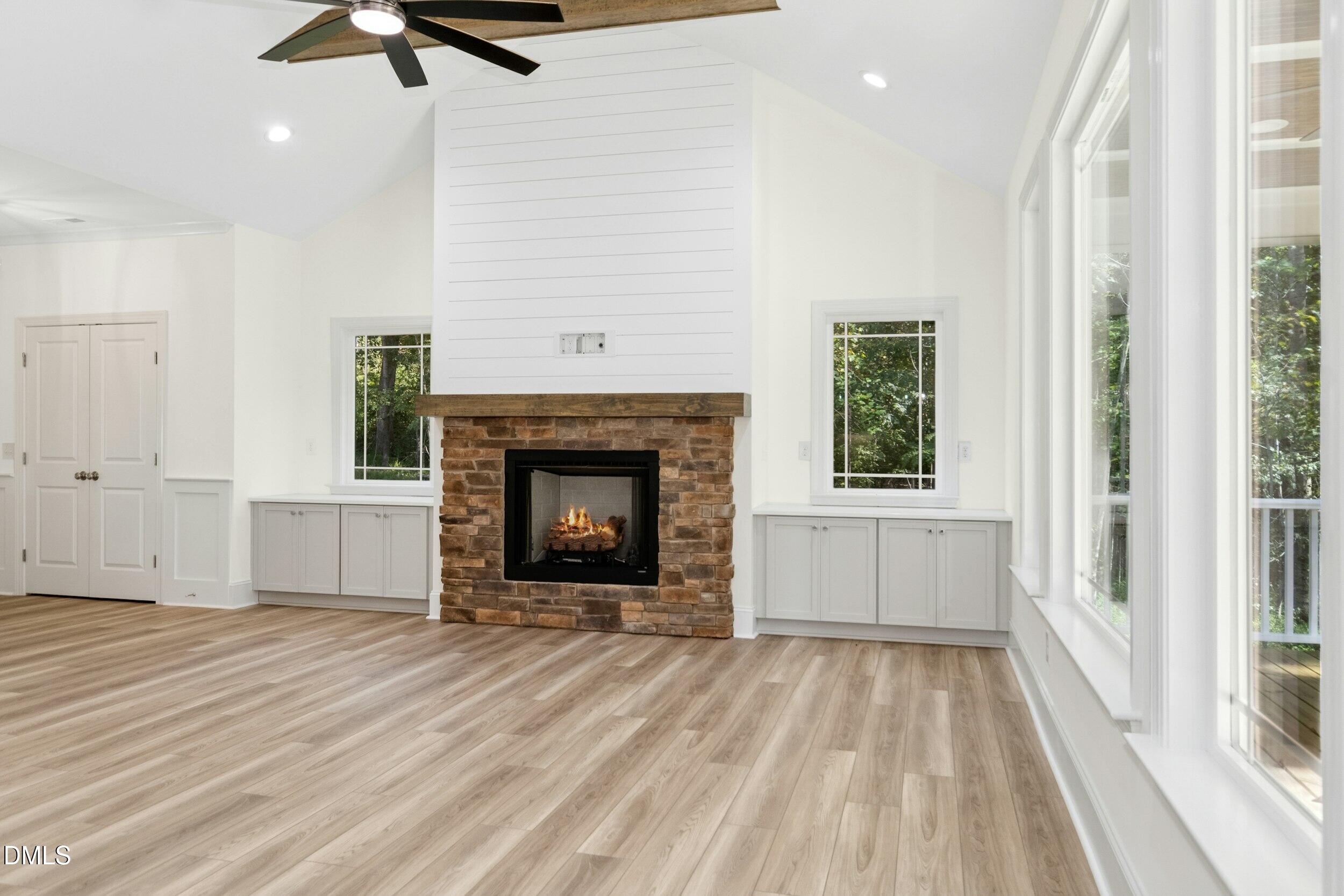 925 Lynch Road Selma, NC 27576 - Photo 16 of 39 a view of a livingroom with a fireplace wooden floor and window