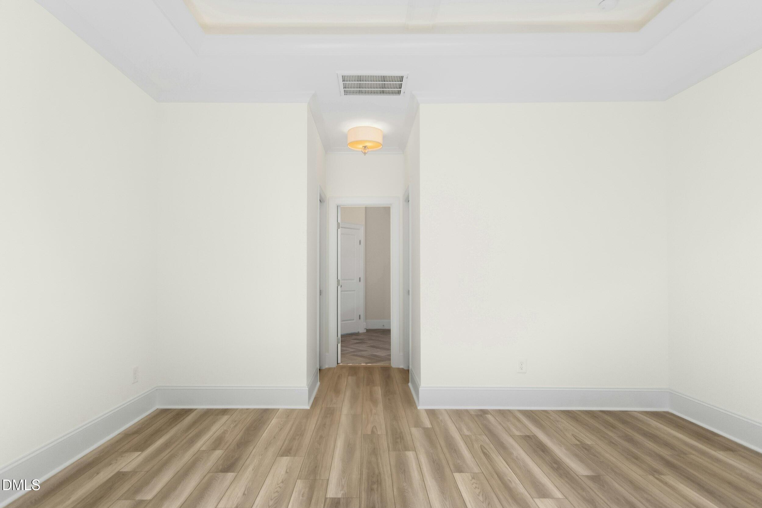 925 Lynch Road Selma, NC 27576 - Photo 18 of 39 a view of a room with wooden floor and a ceiling fan