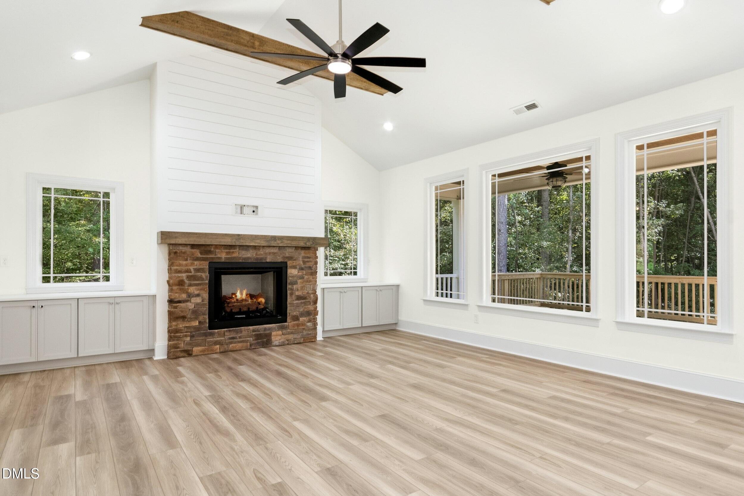 925 Lynch Road Selma, NC 27576 - Photo 2 of 39 a view of an empty room with a fireplace and a window