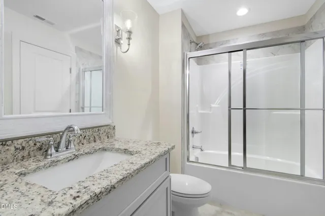 a view of a grassy field with trees in the background