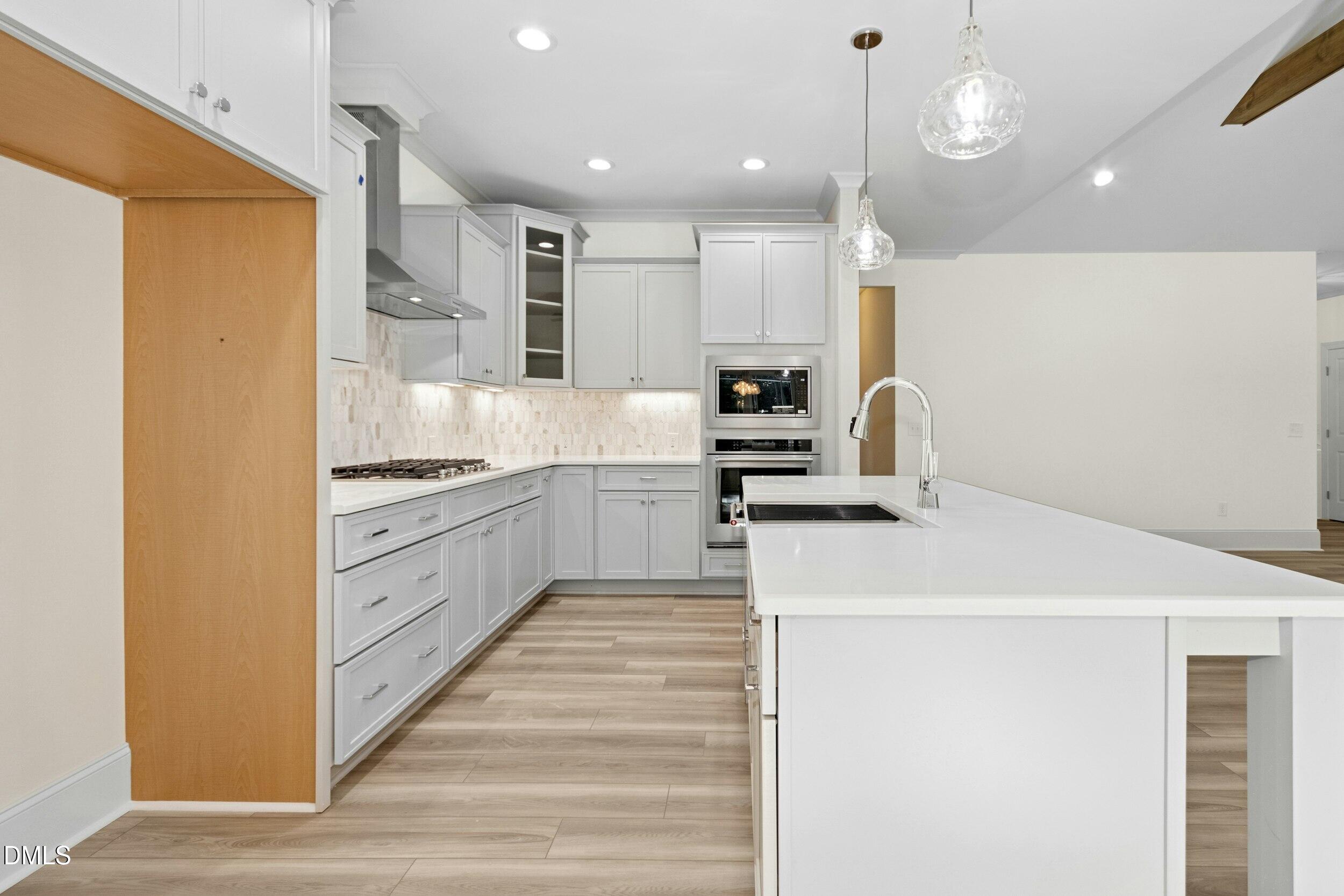 925 Lynch Road Selma, NC 27576 - Photo 4 of 39 a kitchen with kitchen island a sink stainless steel appliances and cabinets