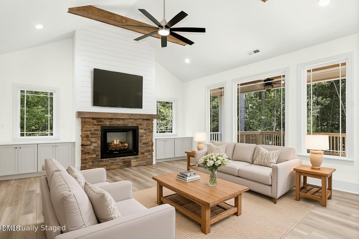 925 Lynch Road Selma, NC 27576 - Photo 6 of 39 a living room with furniture a fireplace and a large window
