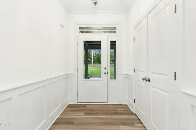 an empty room with windows and a fireplace