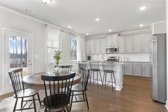 a view of kitchen with cabinets table and chairs