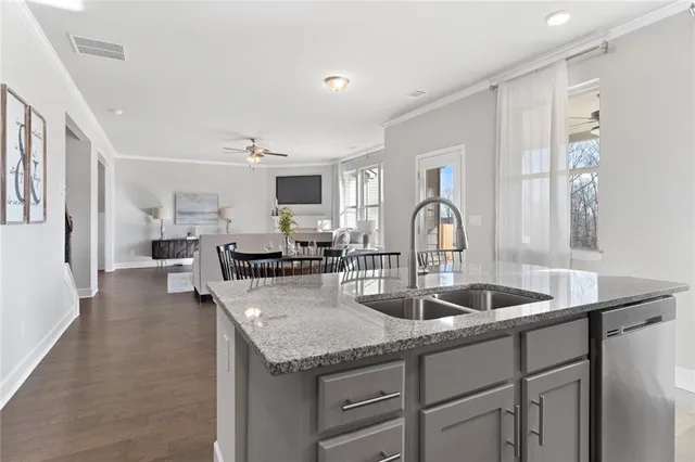 a kitchen with granite countertop a sink and cabinets