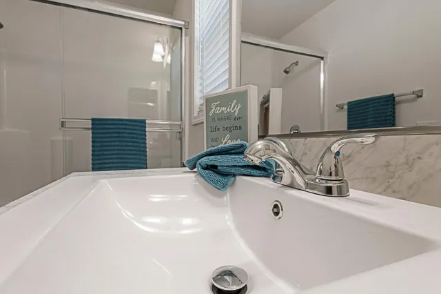 a bathroom with a tub sink and mirror