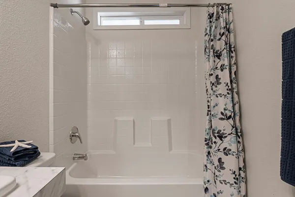 a bathroom with a bathtub and shower