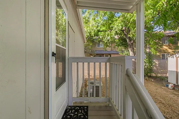 a view of a balcony with wooden floor