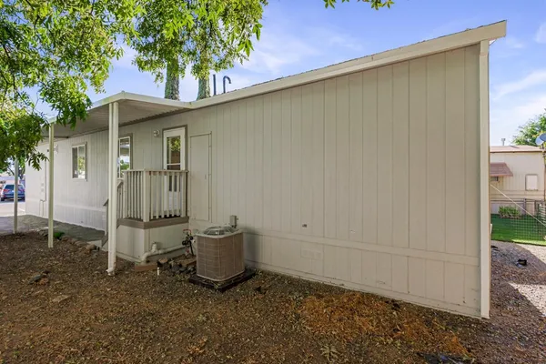 a backyard of a house with table and chairs