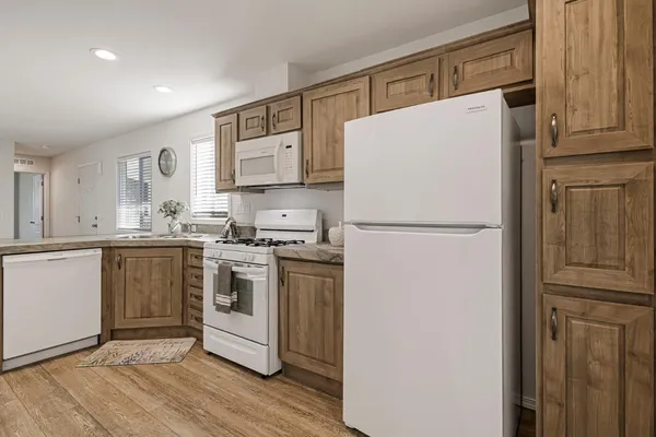 a white refrigerator freezer sitting in a kitchen