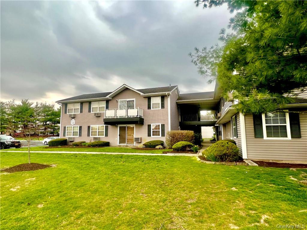 100 Hillside Drive, Unit E16 Middletown, NY 10941 - Photo 1 of 1 a front view of a house with a garden and trees