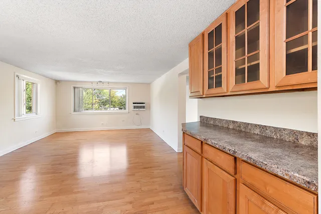 a hallway with granite countertop wooden floors and a window