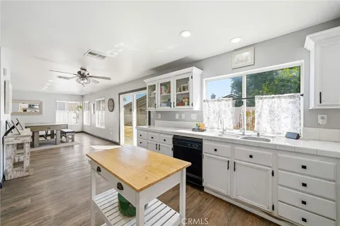 a living room with furniture and view of kitchen