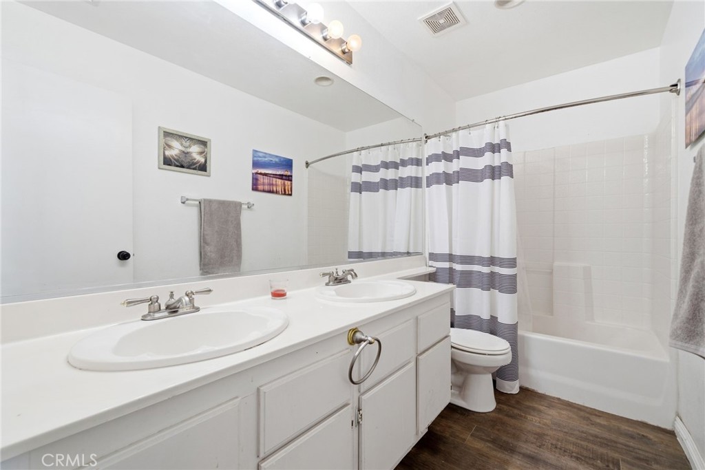 855 Viewtop Circle Corona, CA 92881 - Photo 19 of 52 a bathroom with a granite countertop sink a toilet a large mirror and shower