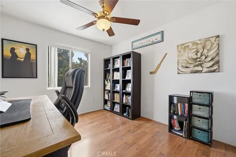 a spacious bedroom with a bed and a flat screen tv