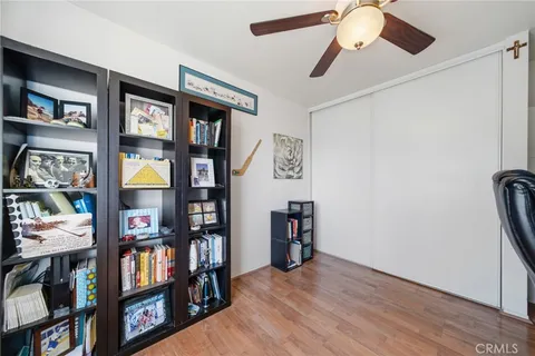 a spacious bedroom with a large bed and a book shelf