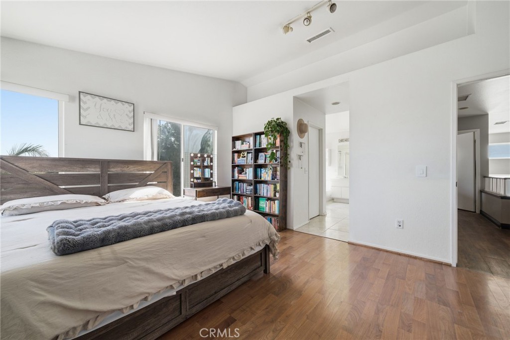 855 Viewtop Circle Corona, CA 92881 - Photo 25 of 52 a spacious bedroom with a large bed and a book shelf