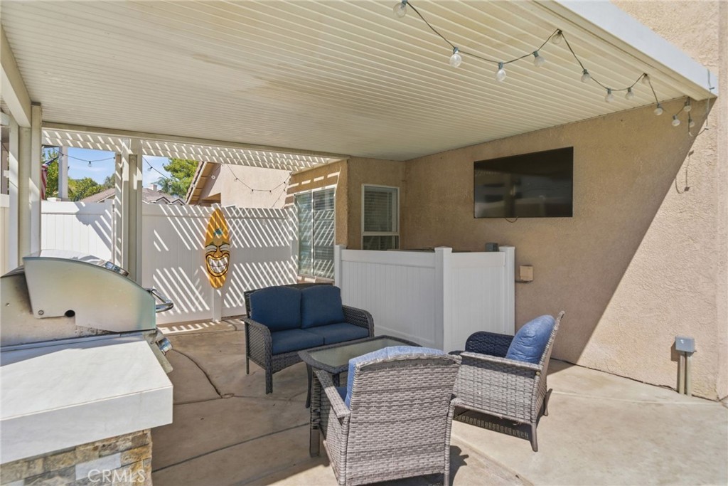 855 Viewtop Circle Corona, CA 92881 - Photo 35 of 52 a living room with furniture a flat screen tv and a large window
