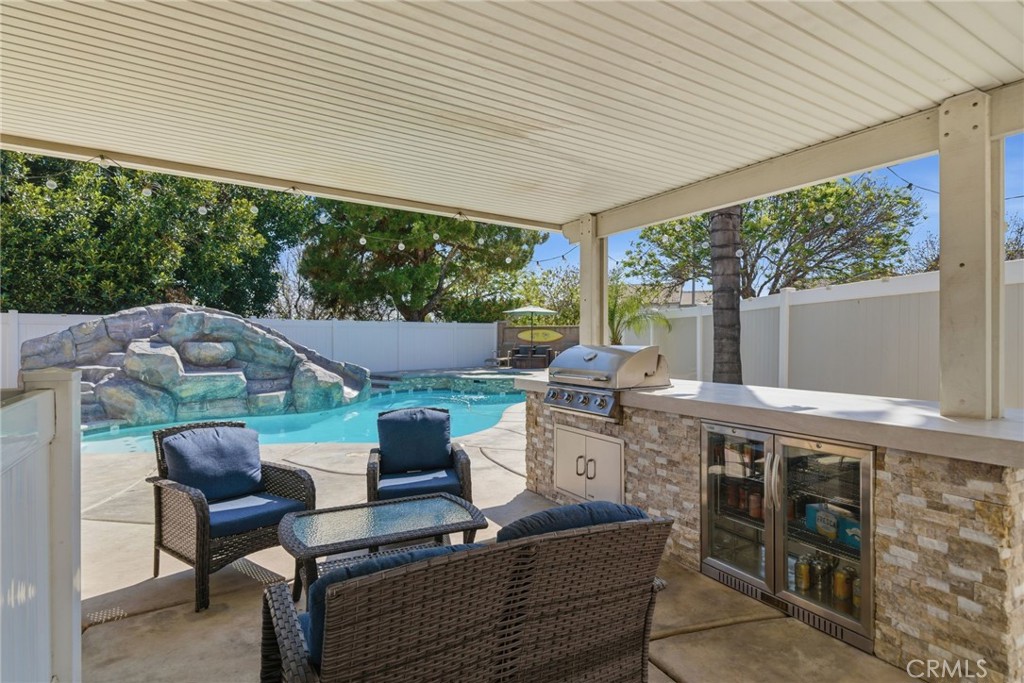 855 Viewtop Circle Corona, CA 92881 - Photo 37 of 52 a view of a patio with table and chairs potted plants with floor to ceiling window
