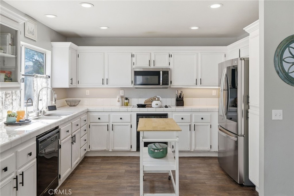 855 Viewtop Circle Corona, CA 92881 - Photo 10 of 52 a kitchen with white cabinets and stainless steel appliances