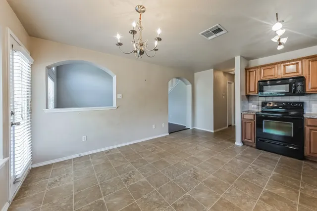 a view of a kitchen with a sink and a fireplace