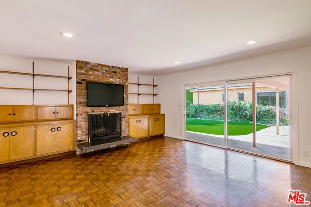 a view of a kitchen with microwave and furniture