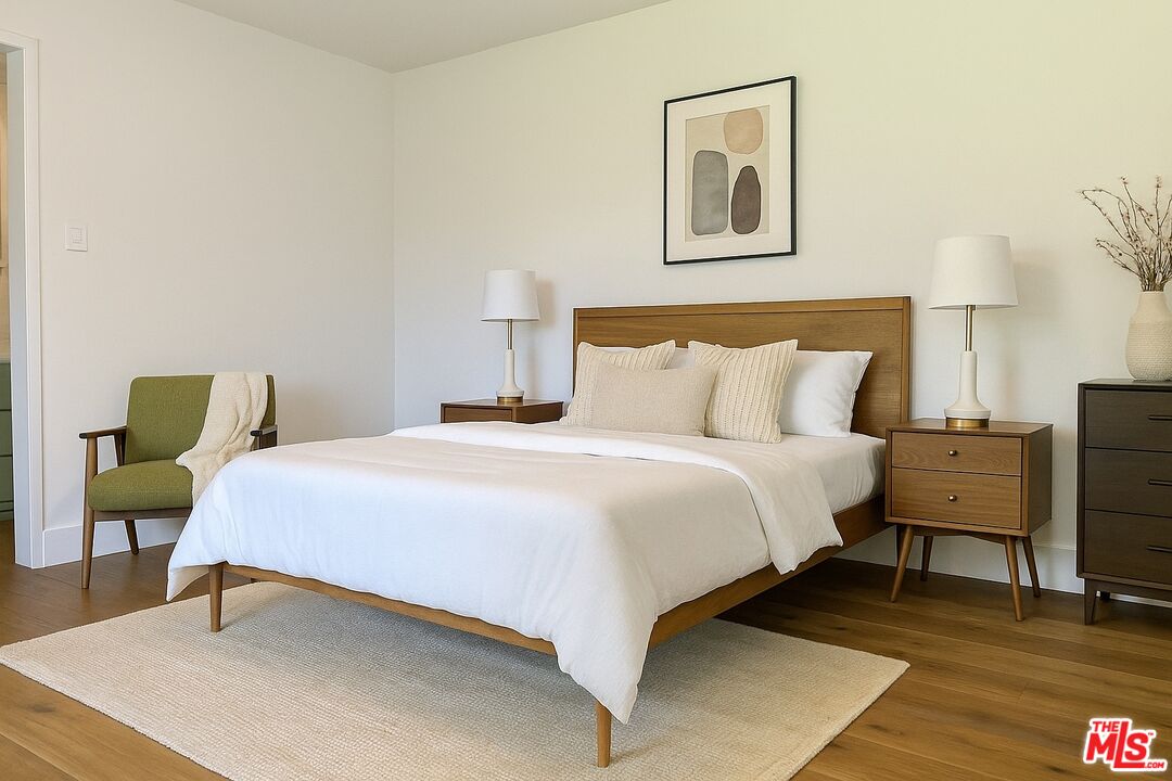 13104 West Magnolia Boulevard Sherman Oaks, CA 91423 - Photo 17 of 27 a bedroom with a bed and painting on the wall