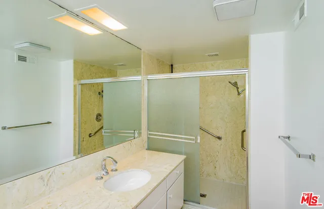 a bathroom with a sink and shower