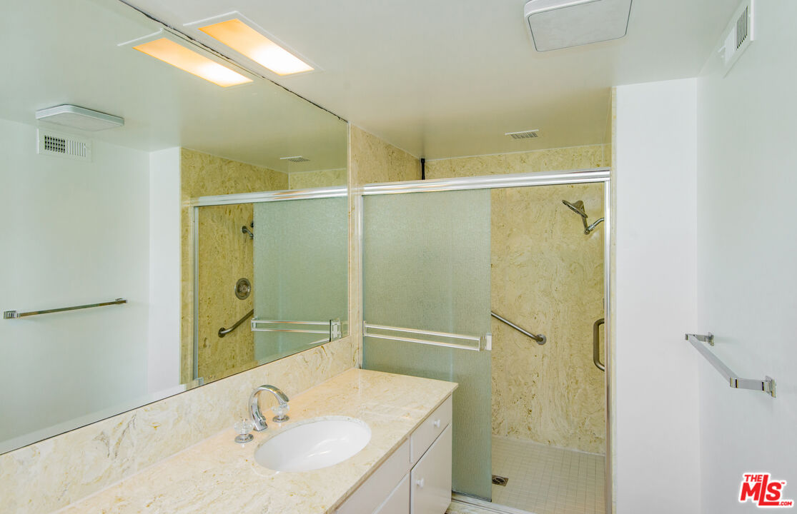 13104 West Magnolia Boulevard Sherman Oaks, CA 91423 - Photo 19 of 27 a bathroom with a sink and shower