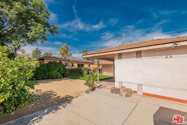 a view of a chair and tables in the patio
