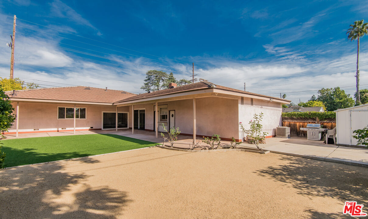13104 West Magnolia Boulevard Sherman Oaks, CA 91423 - Photo 26 of 27 a patio with a table and chairs and a small yard