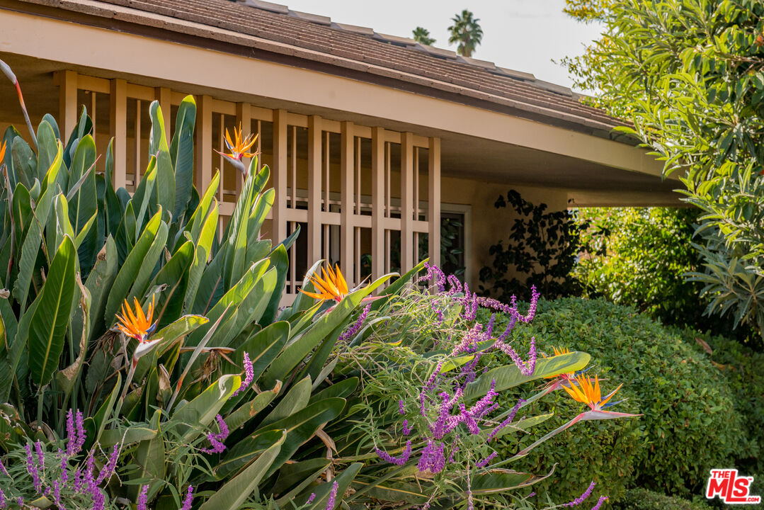 13104 West Magnolia Boulevard Sherman Oaks, CA 91423 - Photo 6 of 27 a front view of a house with a flower garden