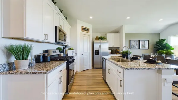 a kitchen with stainless steel appliances granite countertop a sink stove and cabinets