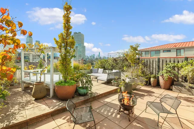 a view of a patio with couches table and chairs and potted plants