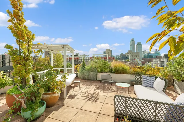 a view of a patio with couches table and chairs and potted plants