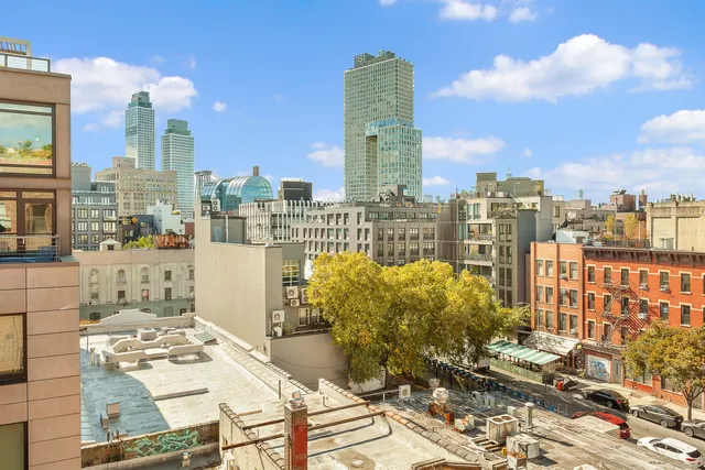 a view of a terrace with furniture and city view