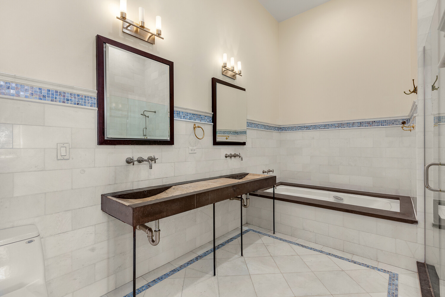 85 North 3rd Street, Unit 510 Brooklyn, NY 11249 - Photo 8 of 18 a bathroom with a sink a light fixture and a mirror