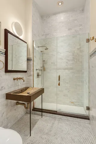 a bathroom with a sink a light fixture and a mirror