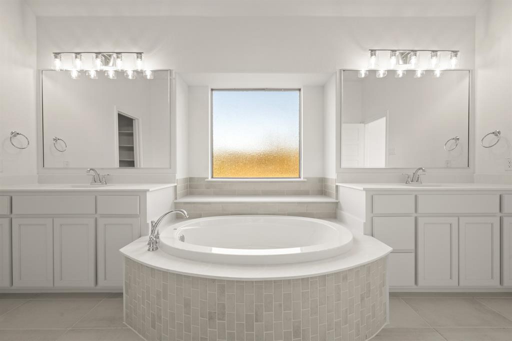 701 Seahawk Street Joshua, TX 76058 - Photo 12 of 30 a bathroom with a tub sink and mirror