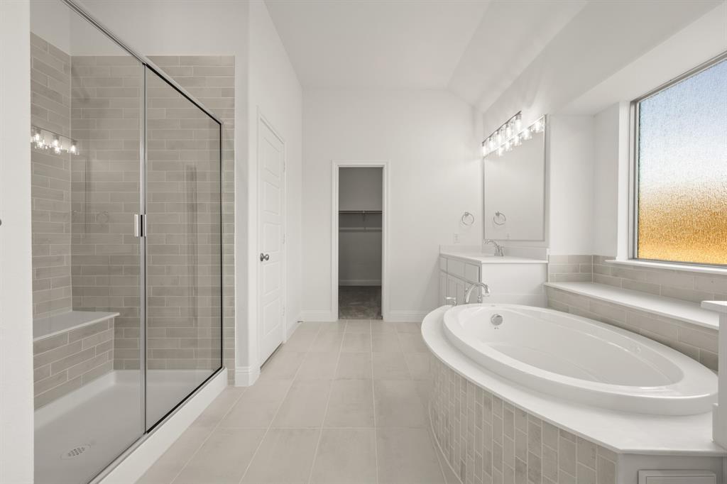 701 Seahawk Street Joshua, TX 76058 - Photo 14 of 30 a white bath tub sitting next to a bathroom