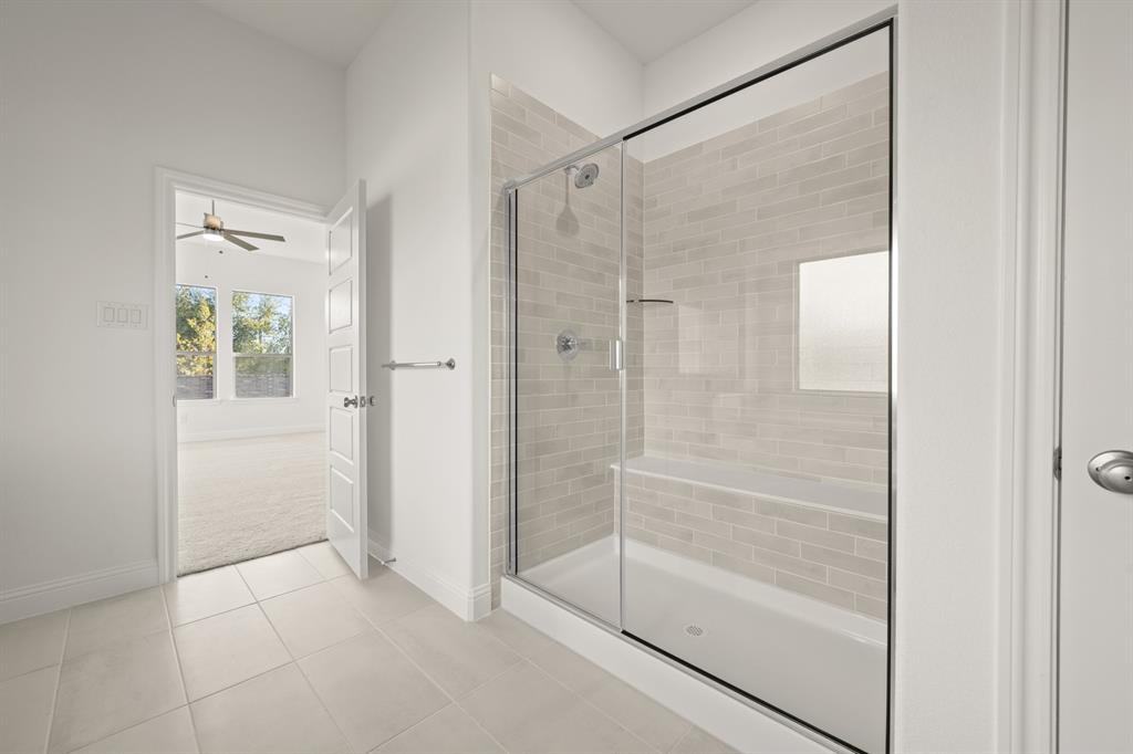 701 Seahawk Street Joshua, TX 76058 - Photo 15 of 30 a bathroom with a glass shower door and a window