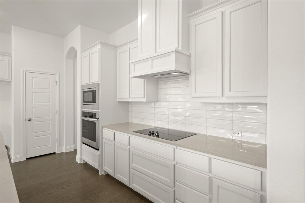 701 Seahawk Street Joshua, TX 76058 - Photo 2 of 30 a kitchen with white cabinets and sink