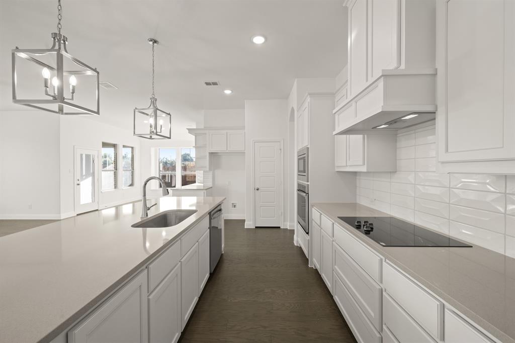 701 Seahawk Street Joshua, TX 76058 - Photo 5 of 30 a large kitchen with stainless steel appliances lots of counter space and a sink